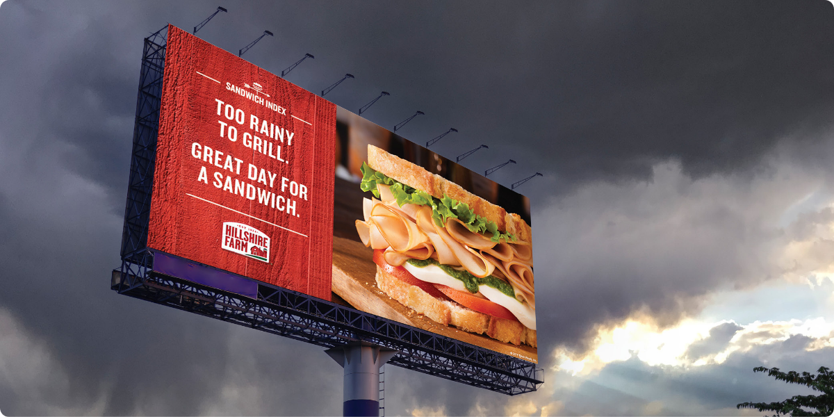 Hillshire Farms billboard against a stormy sky telling people to make a sandwich