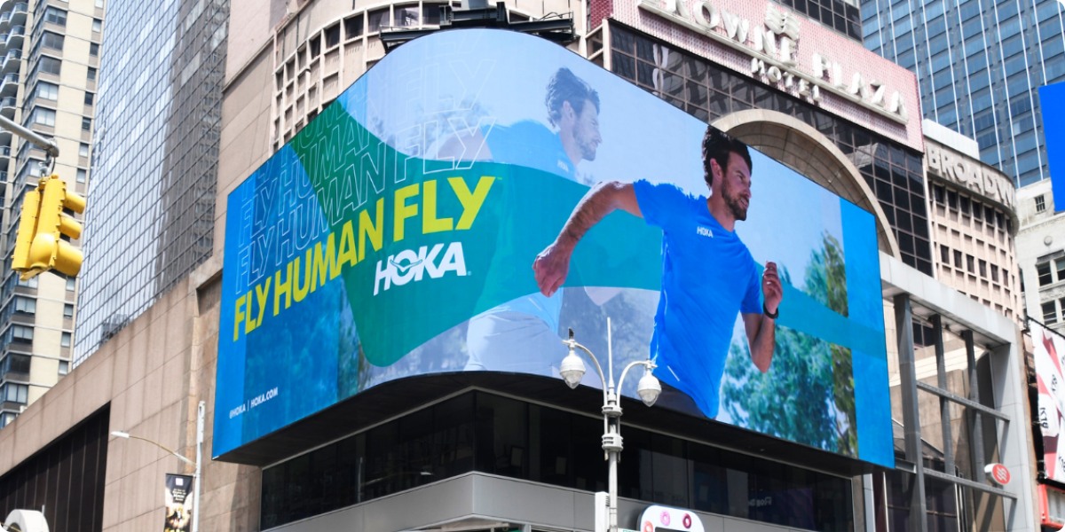 Hoka digital billboard that says fly human fly