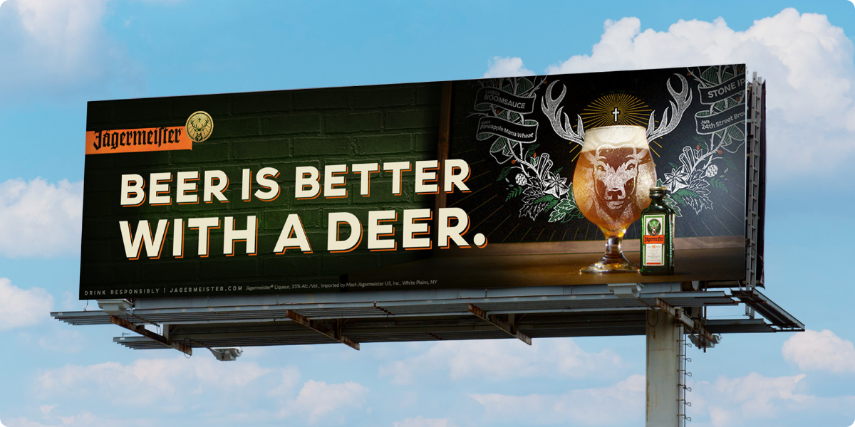 Jägermeister billboard that says "beer is better with a deer"